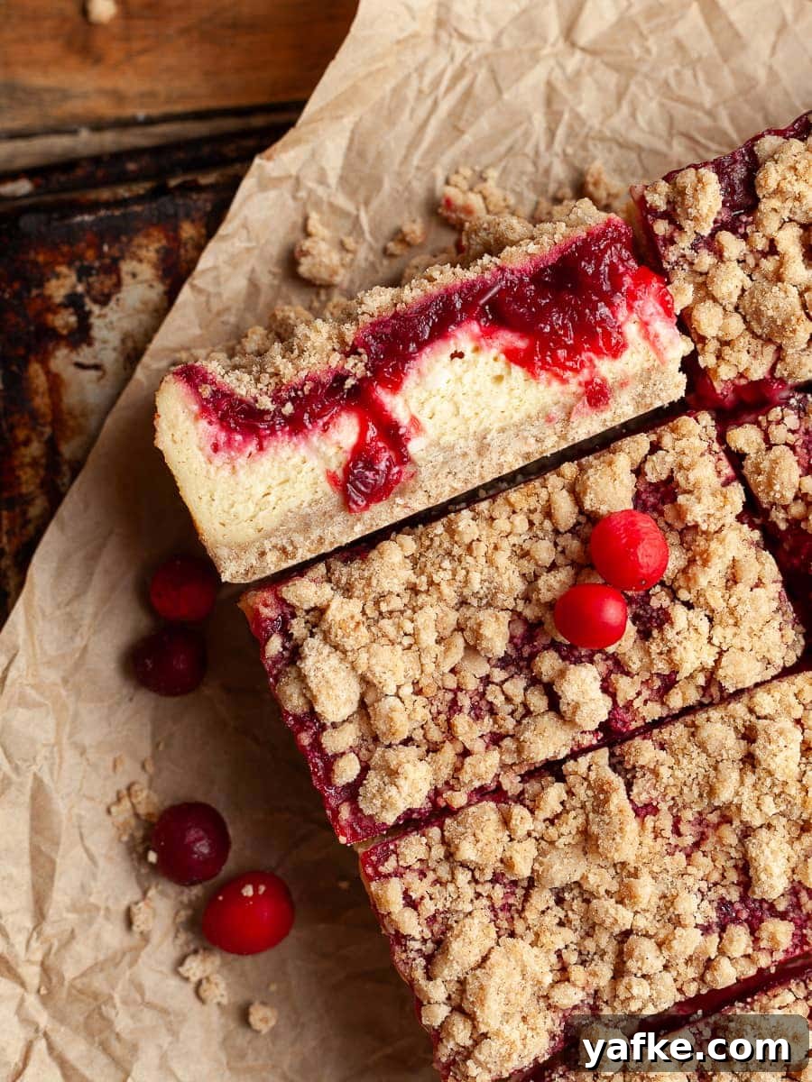 Gluten-Free Cranberry Cheesecake Bars Recipe 9 Sliced gluten free cranberry cheesecake bars topped with cranberry sauce and streusel