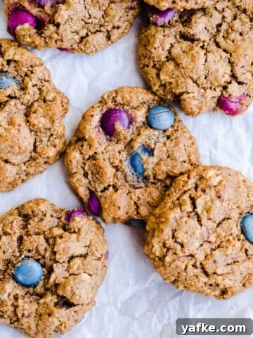Freshly baked monster cookies on parchment.