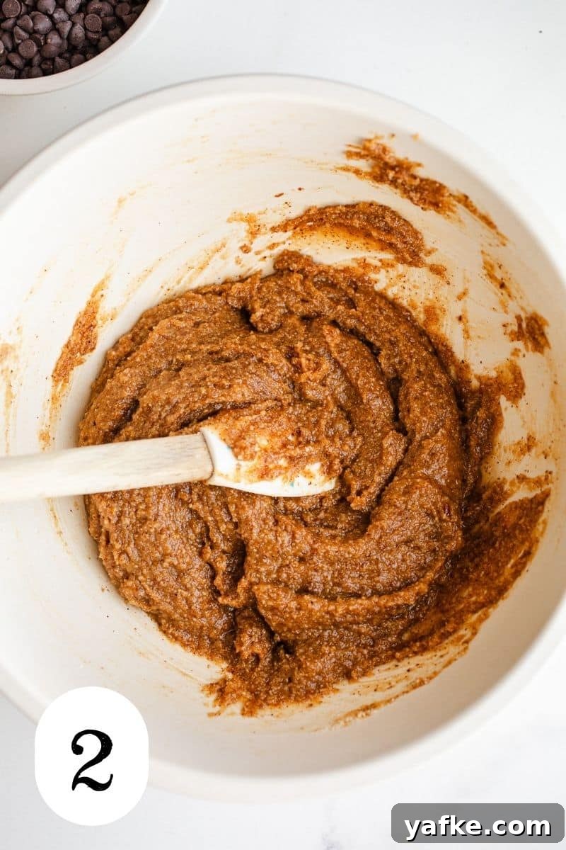 Chewy Almond Butter Chocolate Chip Cookies 4 Almond cookie dough in a mixing bowl.