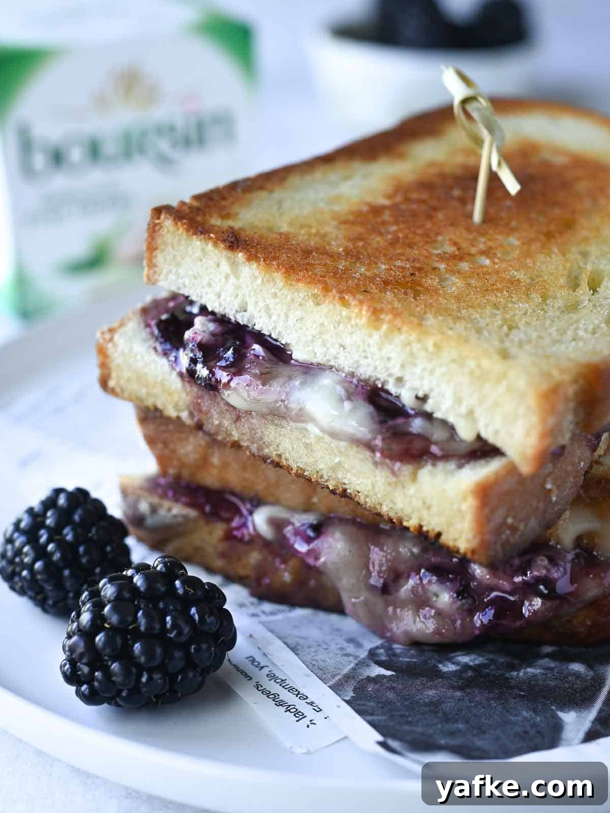 Boursin and Blackberry Grilled Cheese Sandwich 2 Blackberry boursin grilled cheese on a white plate with blackberries in the foreground.