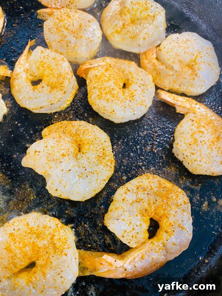 Spicy Buffalo Shrimp over Creamy Cheddar Grits 5 cooking the shrimp on a skillet