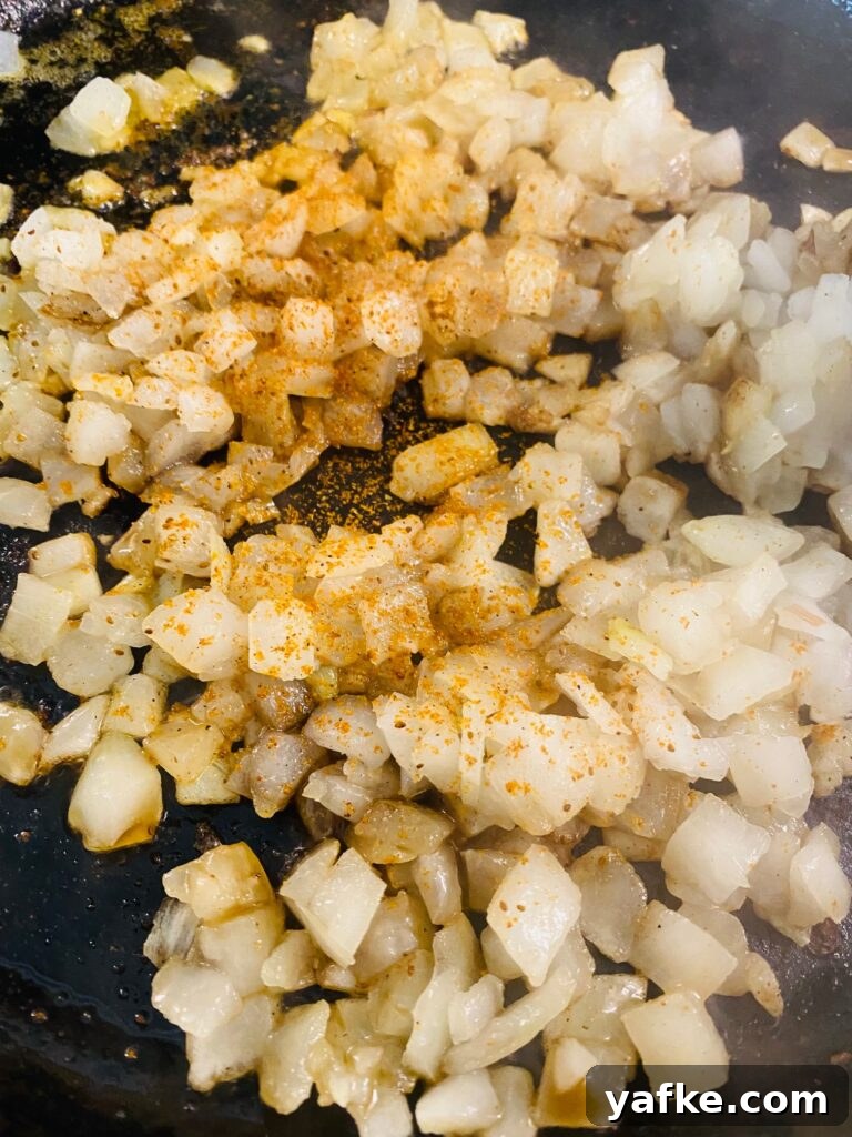 Spicy Buffalo Shrimp over Creamy Cheddar Grits 7 adding onions to the skillet