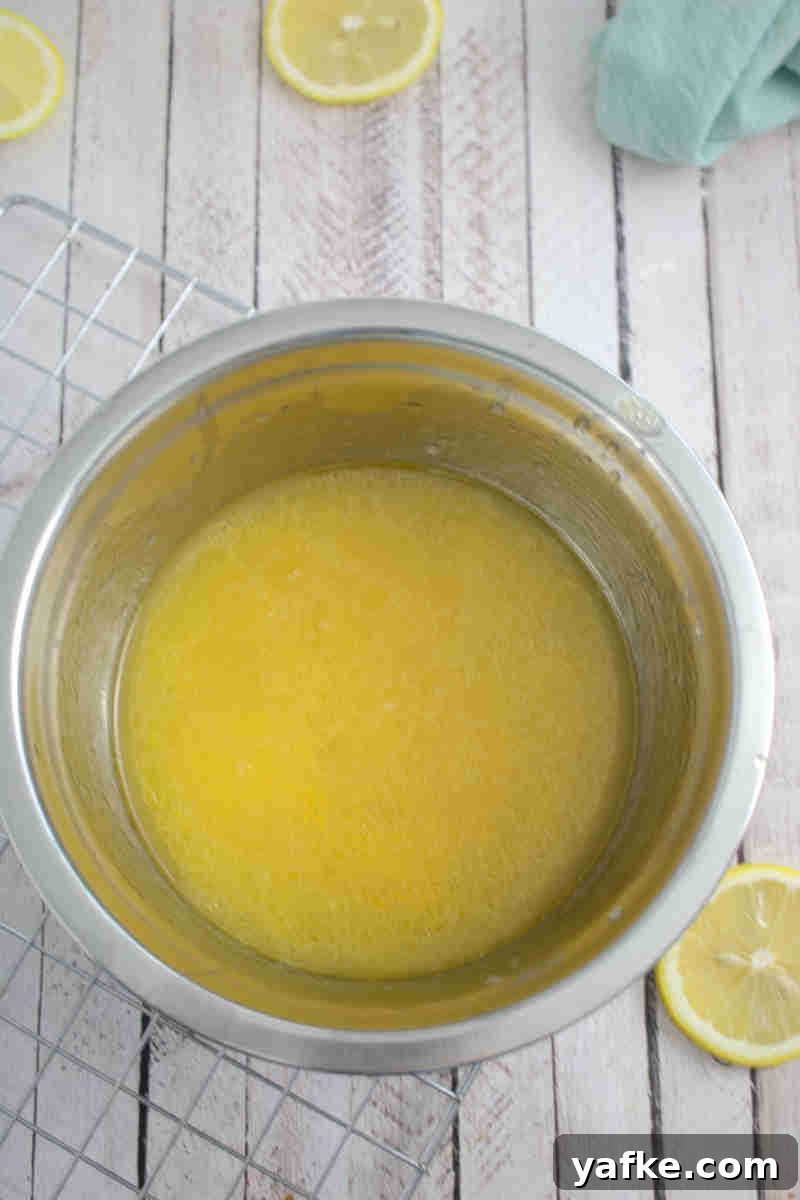Zesty Gluten Free Lemon Protein Muffins Recipe 4 Steel bowl with lemon juice and egg mixed together.