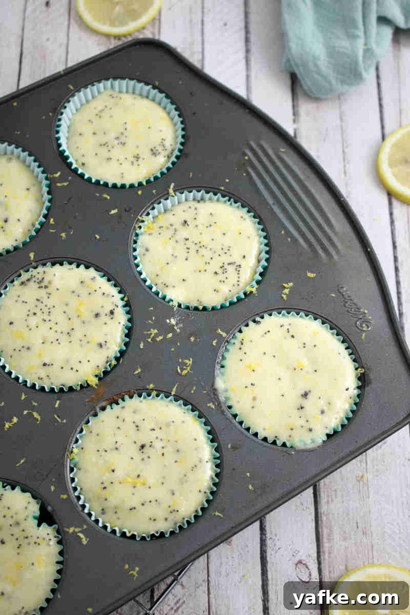 Zesty Gluten Free Lemon Protein Muffins Recipe 7 Raw gluten-free lemon muffin batter in a muffin tin.
