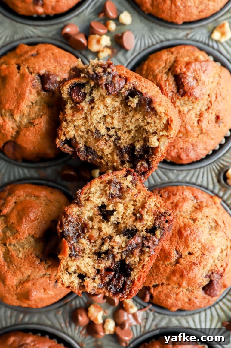 Banana bread muffin cut in half with chocolate and nuts