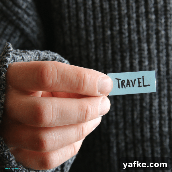 Smart Labeling Tips for Traveling with Kids 2 A hand holding a small label, emphasizing the importance of organization and labeling for stress-free travel with kids.
