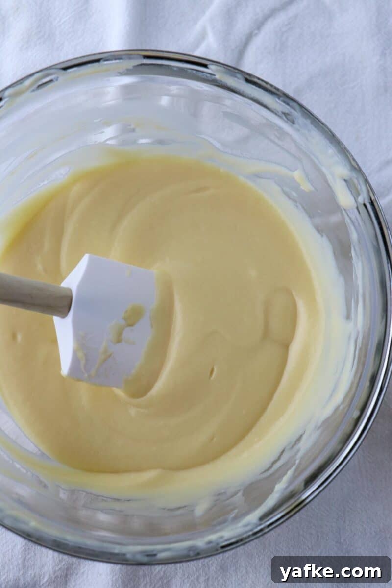 Vaniljhjärtan: Buttery Swedish Custard Heart Cookies 10 Pastry cream in a glass bowl with a rubber spatula.