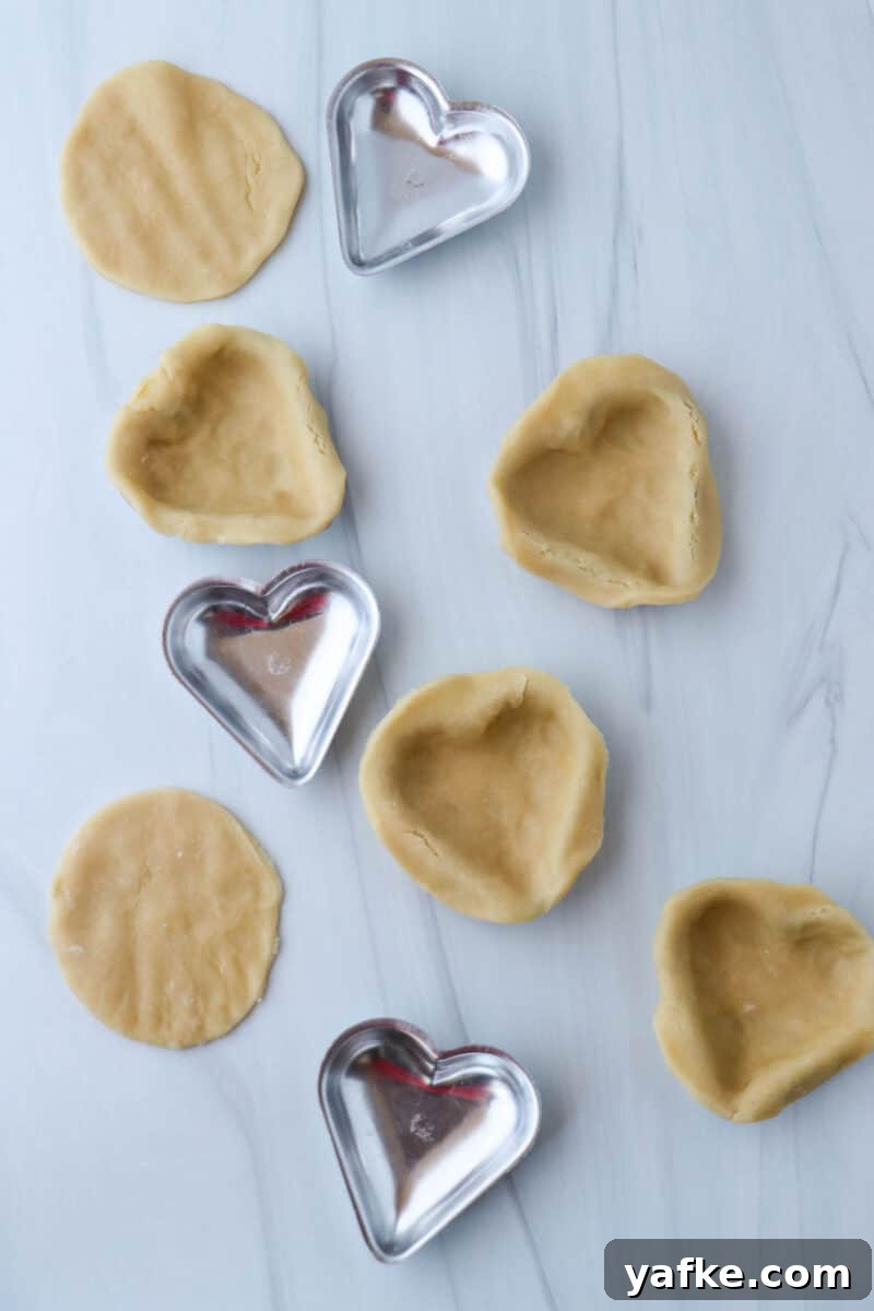 Vaniljhjärtan: Buttery Swedish Custard Heart Cookies 12 Heart shaped molds filled with pastry dough.