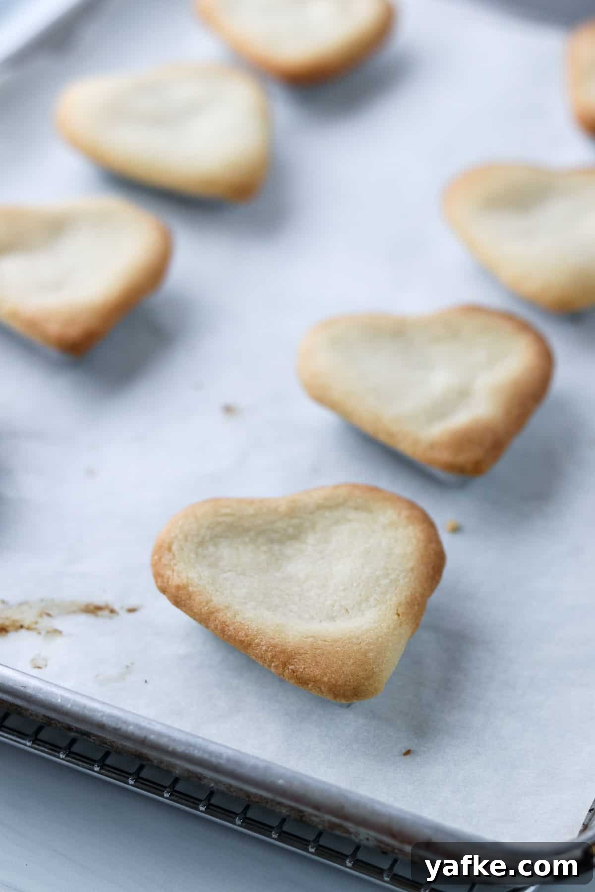 Vaniljhjärtan: Buttery Swedish Custard Heart Cookies 15 Baked Swedish Custard Hearts on a baking sheet.