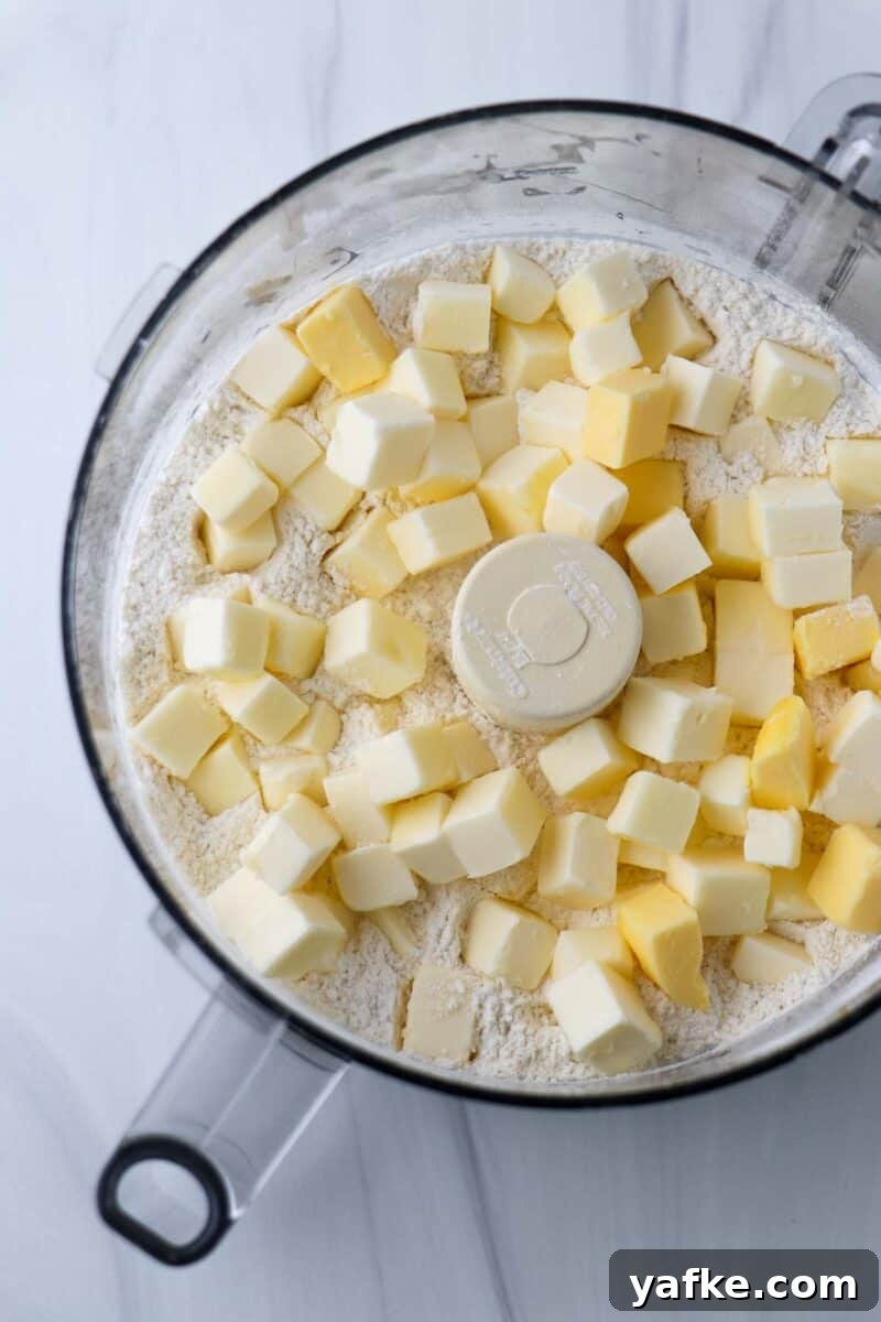 Vaniljhjärtan: Buttery Swedish Custard Heart Cookies 5 Flour and cubes of butter in the work bowl of a food processor.