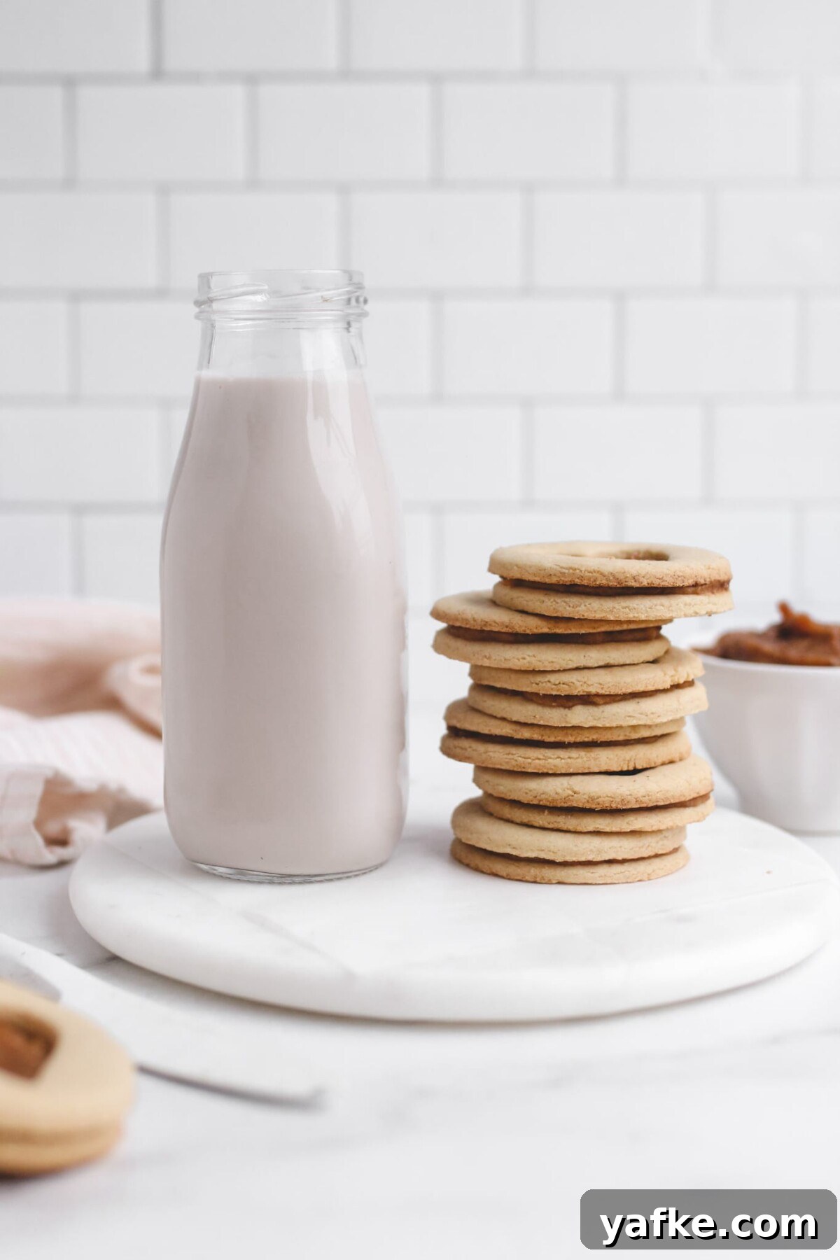 Vegan Gluten-Free Salted Caramel Cookies Recipe 2 a stack of salted caramel cookies next to a glass of milk