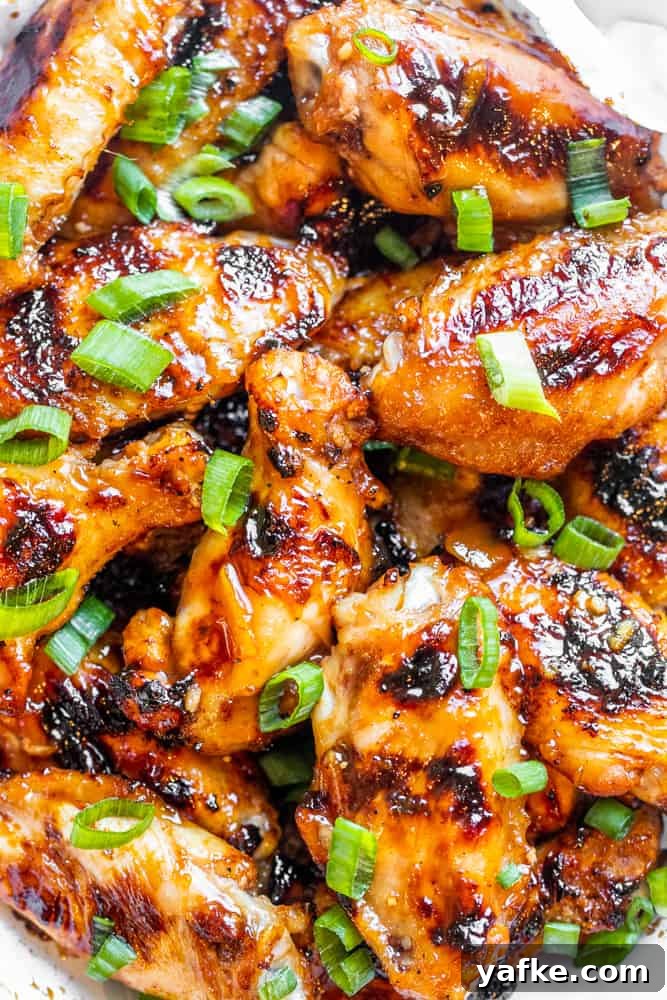 Overhead shot of chicken wings in a bowl together.