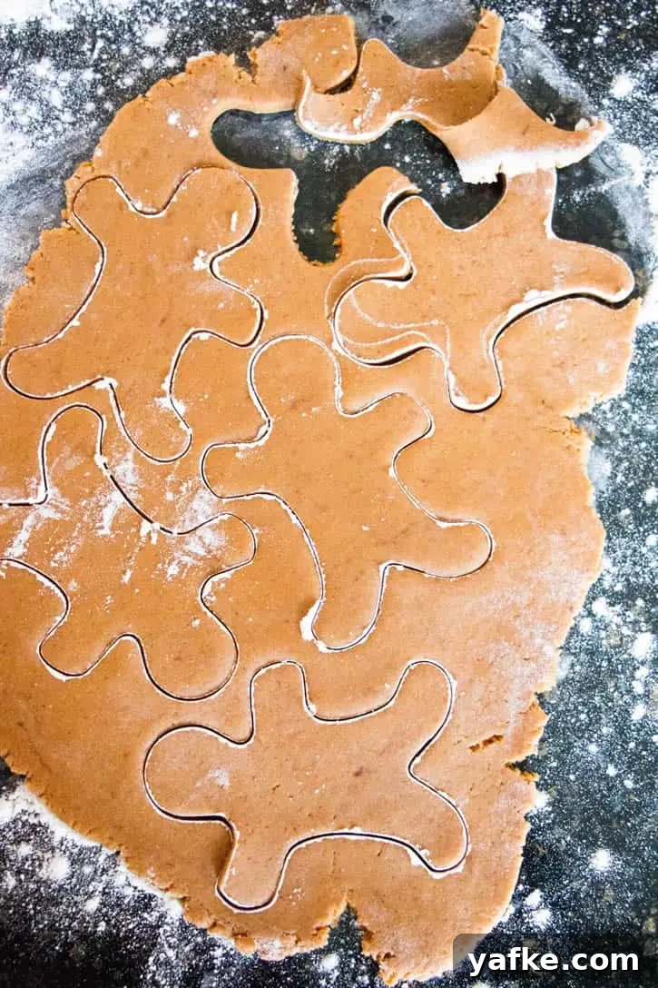 Soft Gingerbread Cookies with Molasses and Warm Spices 5 Rolled gingerbread cookie dough with cut-out gingerbread men to make Soft Gingerbread Cookies by themerchantbaker.com