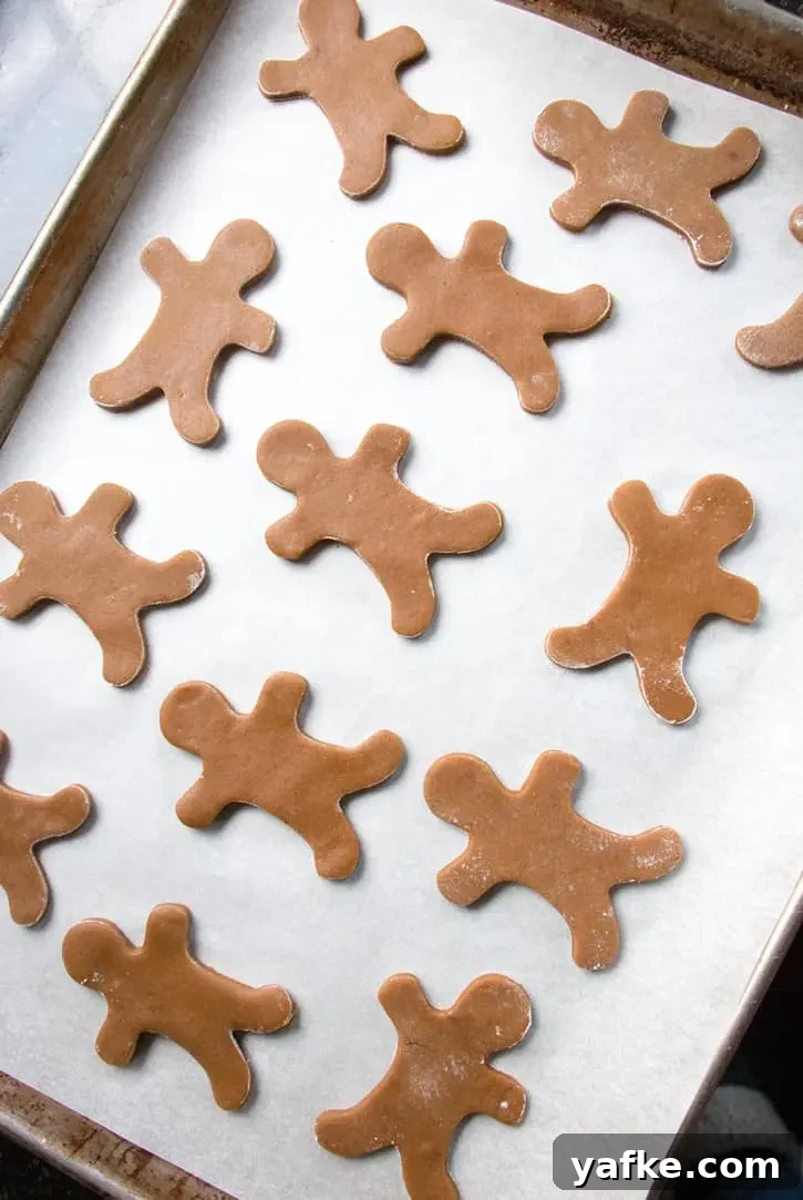 Soft Gingerbread Cookies with Molasses and Warm Spices 6 Raw gingerbread men on a baking tray to make by themerchantbaker.com