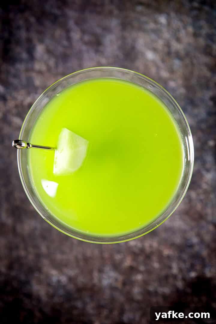 Melon Ball Cocktail Recipe: How to Make the Classic Drink 11 Overhead view of the green cocktail in the martini glass with melon on a pick