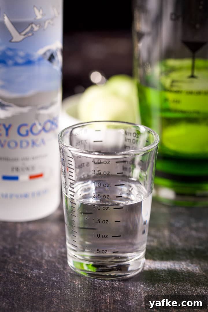 Melon Ball Cocktail Recipe: How to Make the Classic Drink 6 Vodka measured out with the bottle and shaker in the background