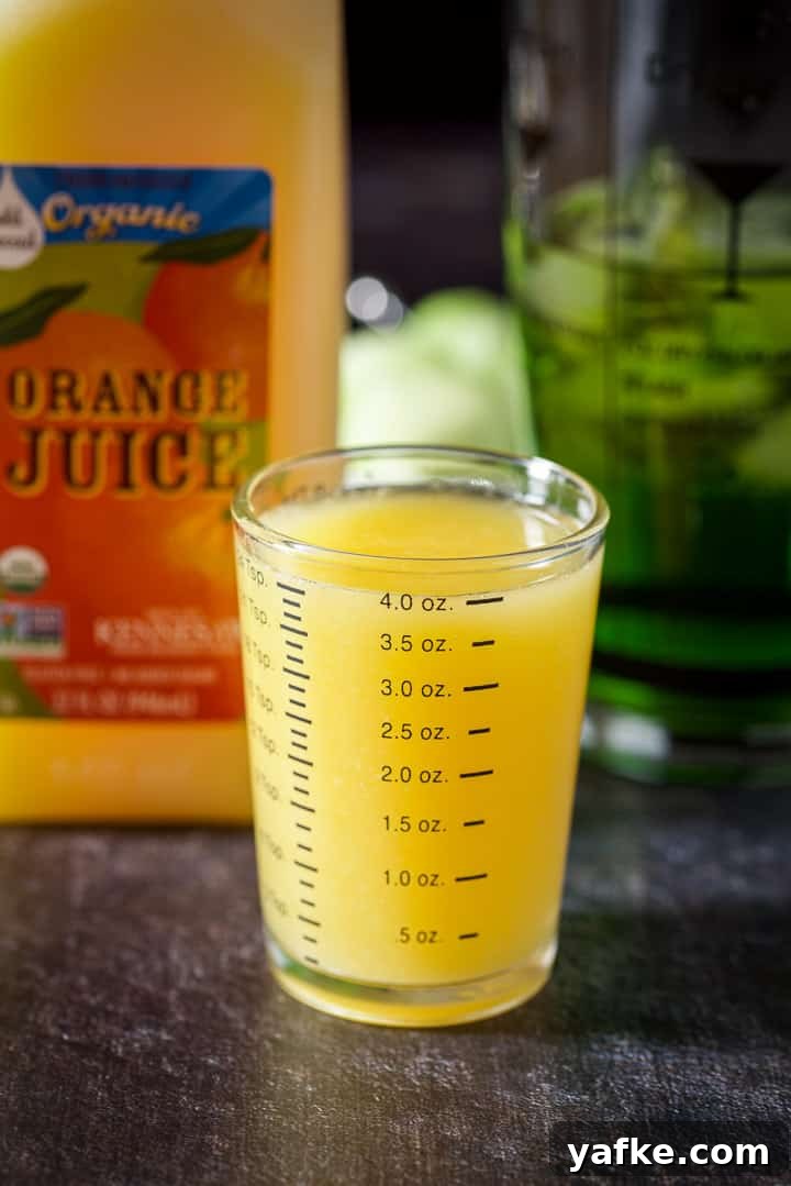 Melon Ball Cocktail Recipe: How to Make the Classic Drink 7 Orange juice measured out with the carton and shaker in the background