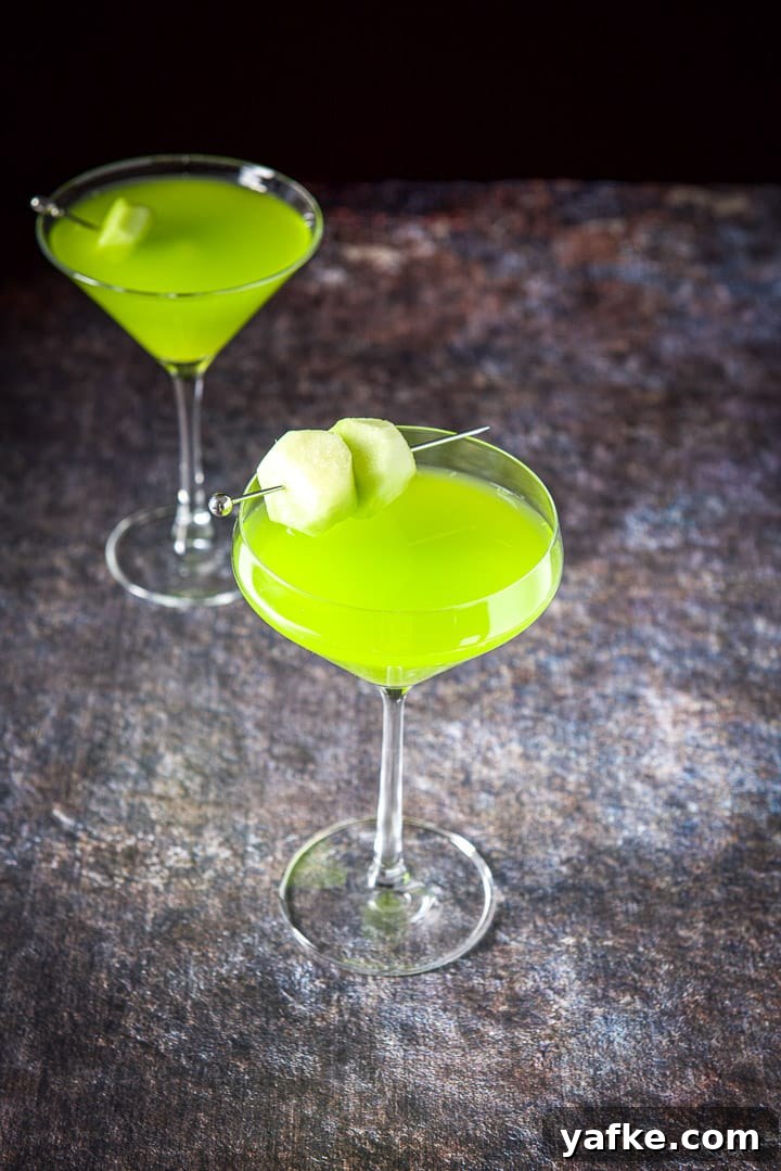 Melon Ball Cocktail Recipe: How to Make the Classic Drink 8 The curved glass in front of the classic glass filled with the green cocktail
