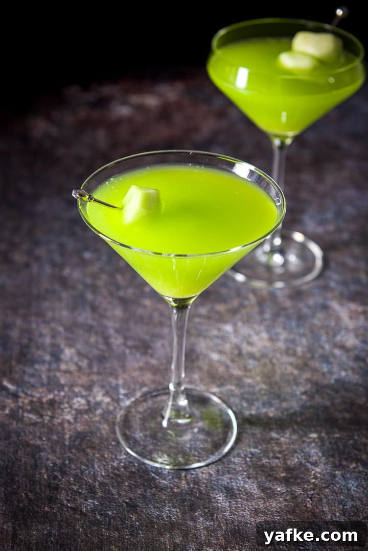 Melon Ball Cocktail Recipe: How to Make the Classic Drink 9 Classic glass in front of the fancy glass filled with the melon drink with the melon as garnish