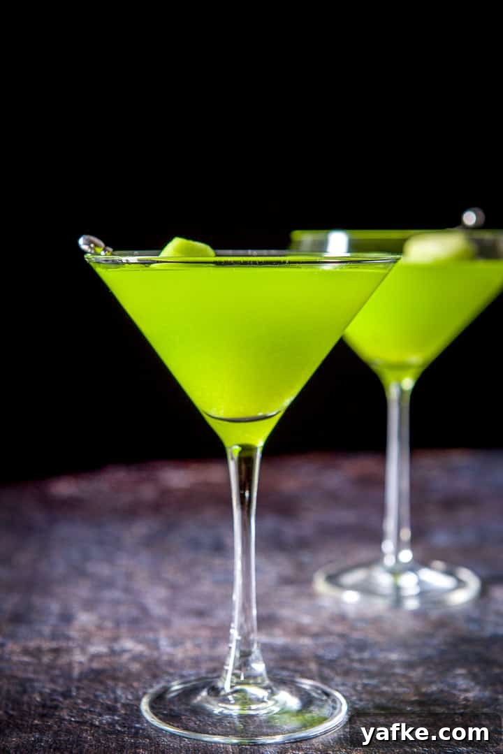 Melon Ball Cocktail Recipe: How to Make the Classic Drink 10 Vertical view of the classic glass filled with the melon drink with the fruit in it
