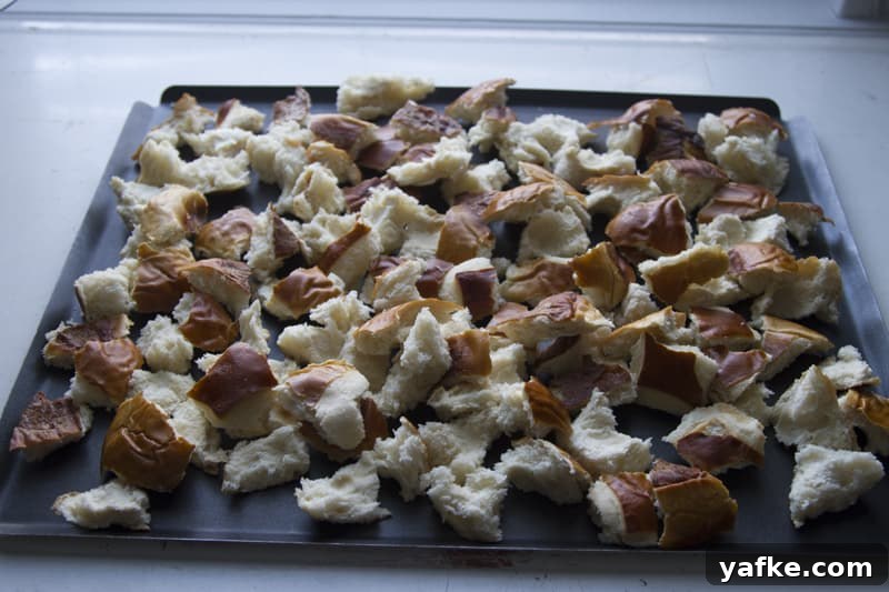 Salted Caramel Pretzel Banana Bread Pudding Recipe 5 Torn pretzel buns on a baking sheet.