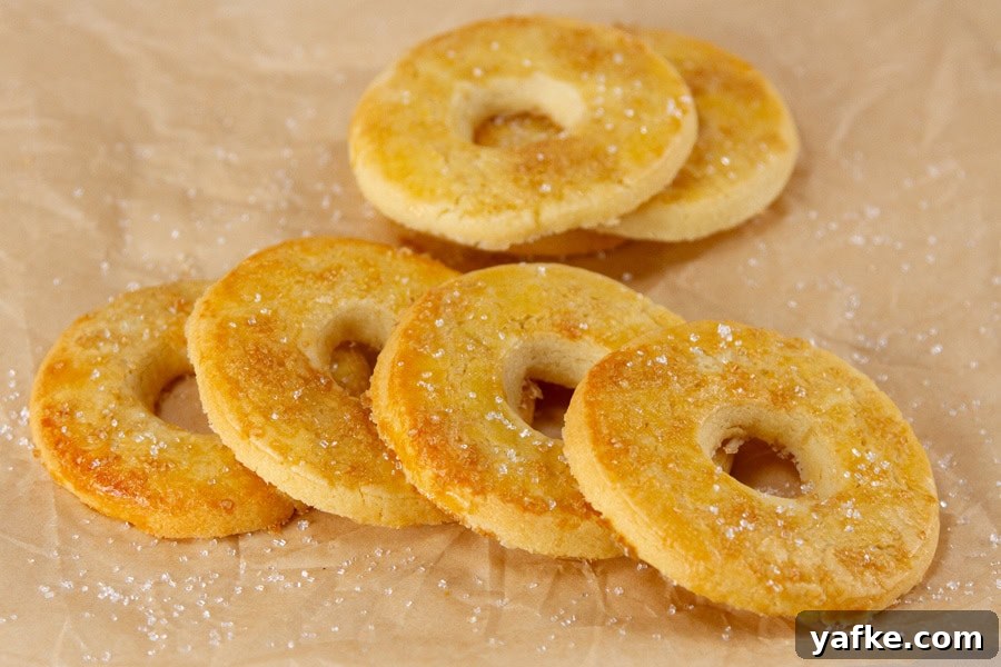 Classic Danish Salted Butter Cookies Recipe 10 Several butter cookies on brown parchment paper.