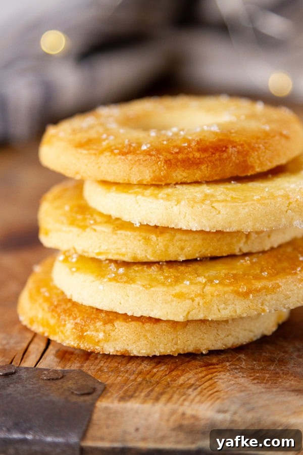 Classic Danish Salted Butter Cookies Recipe 4 A stack of butter cookies on a wooden tray.