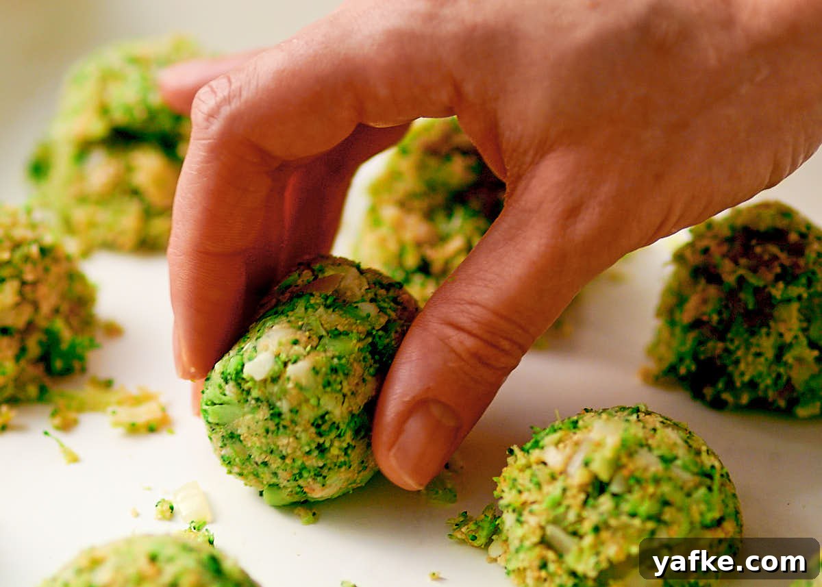 Crispy Air Fryer Broccoli Tater Tots 8 Hand shaping broccoli tater tots before they're baked in an air fryer.