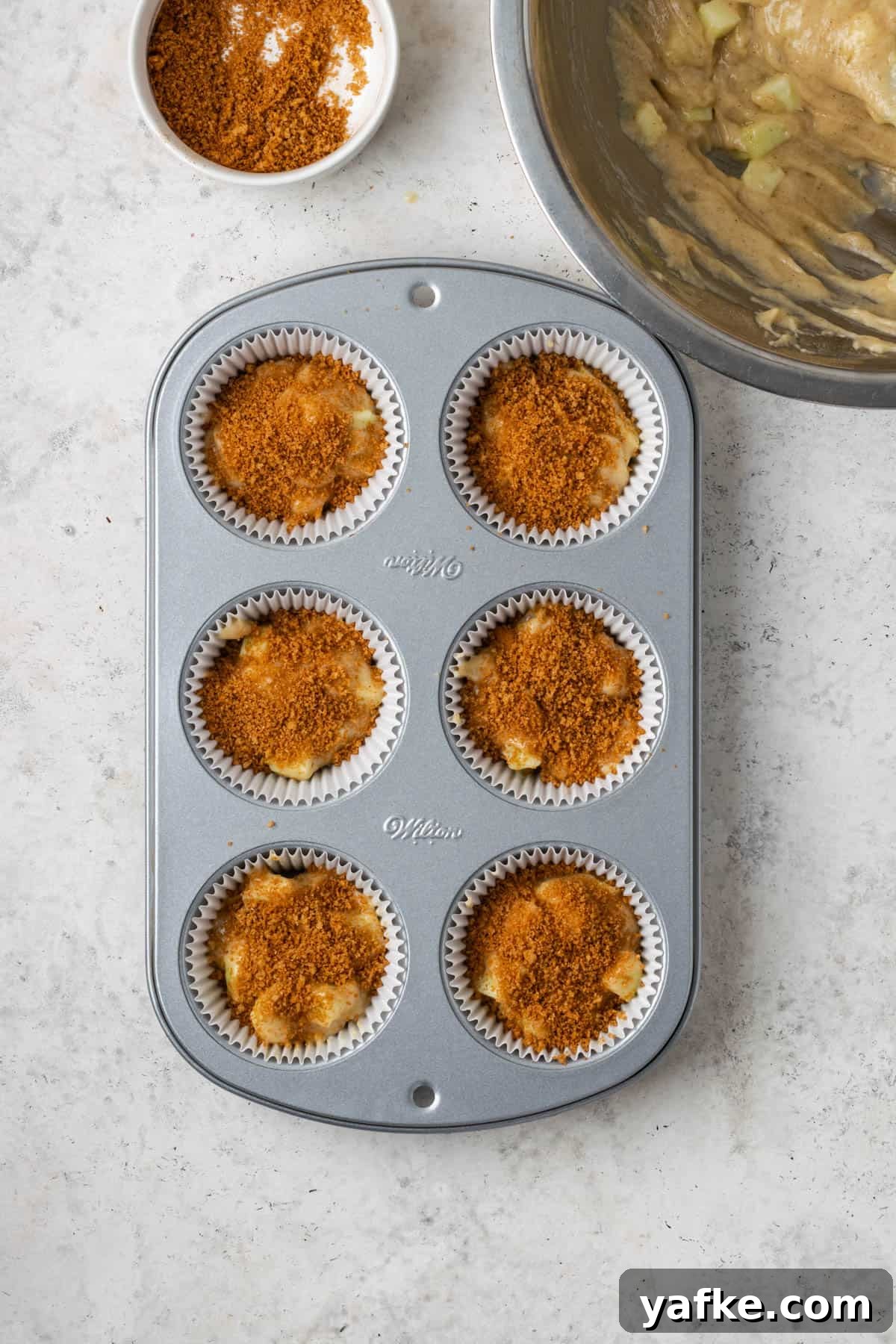 Gluten-Free Apple Cinnamon Muffins 11 Cinnamon sugar sprinkled over apple muffin batter.