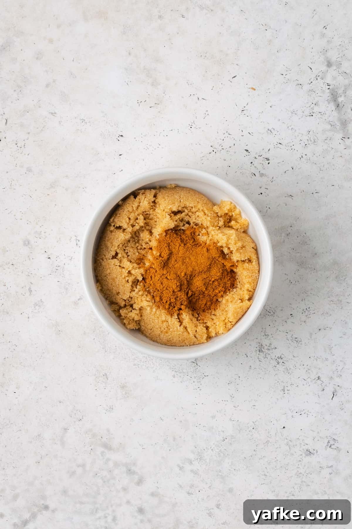 Gluten-Free Apple Cinnamon Muffins 4 Brown sugar and cinnamon combined together in a small white bowl.