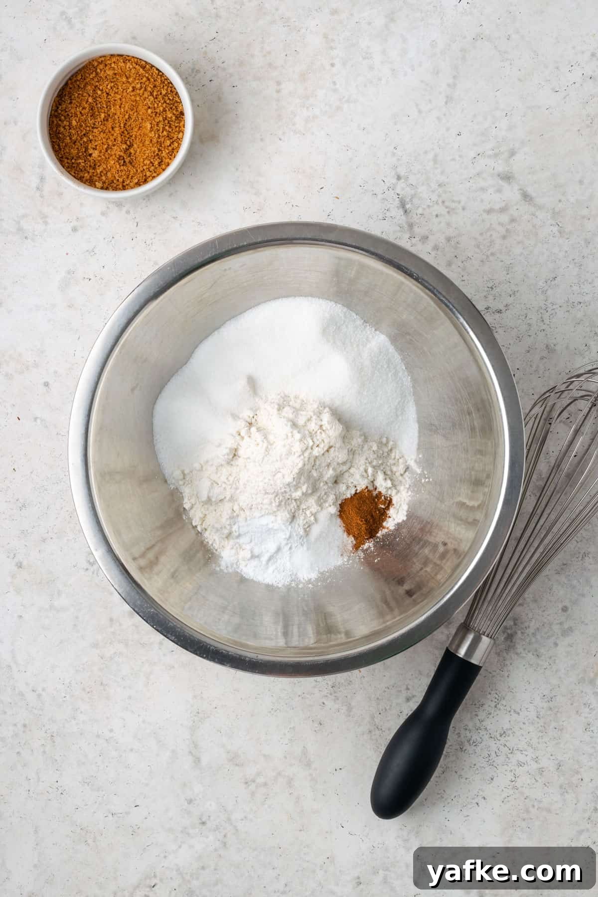 Gluten-Free Apple Cinnamon Muffins 5 Gluten free flour, sugar, baking powder, salt and apple pie spice combined together in a metal mixing bowl.