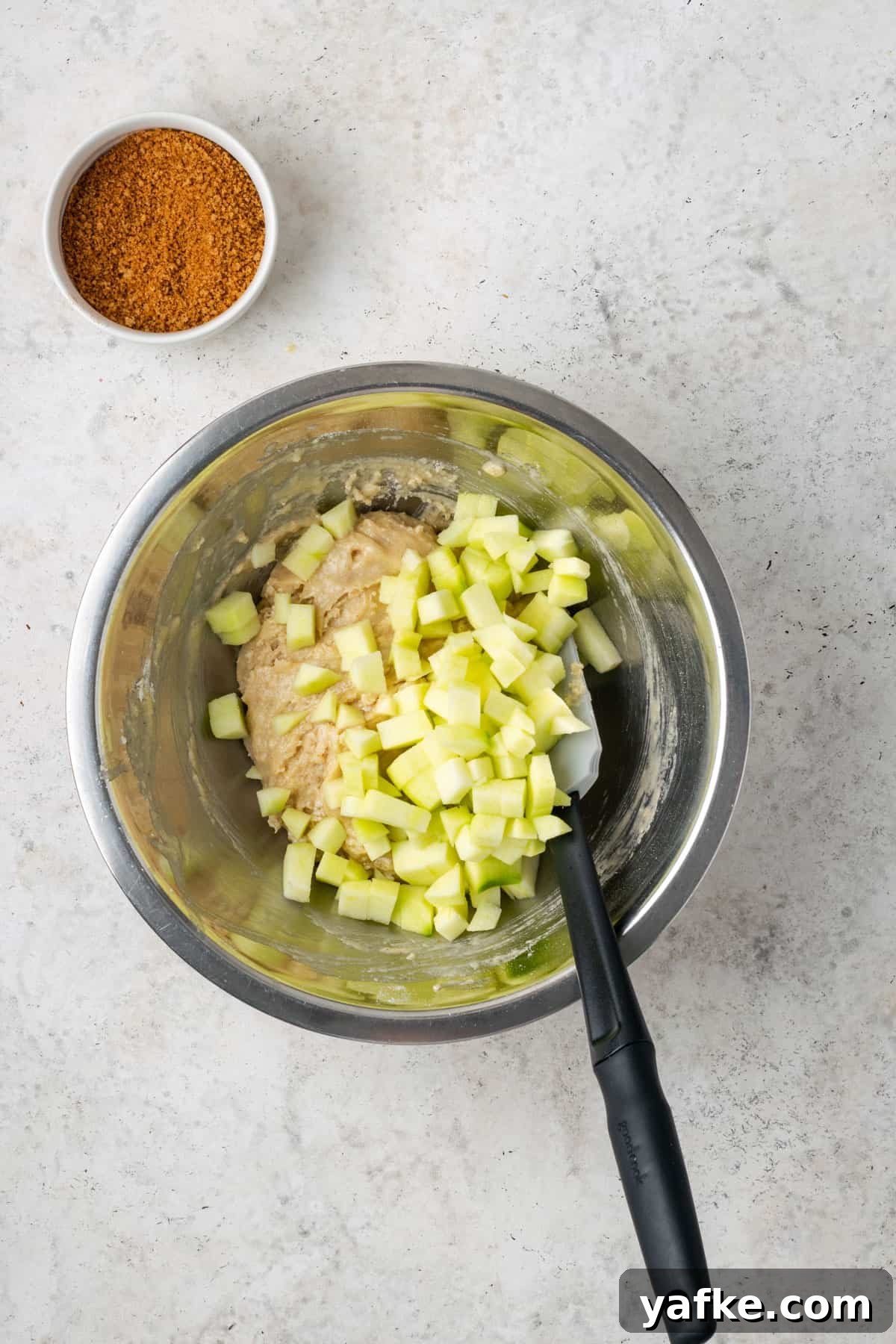 Gluten-Free Apple Cinnamon Muffins 9 Diced apples added to the partially mixed muffin batter.