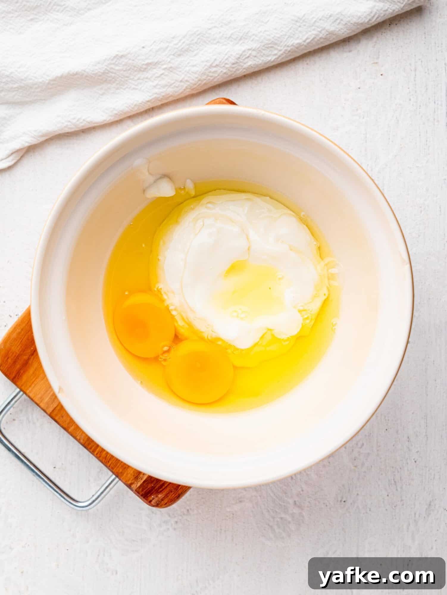 High-Protein Butter-Free Biscuits Recipe 7 Yogurt and eggs in a mixing bowl.