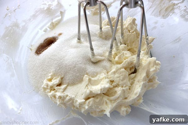Beating cream cheese, sugar, and vanilla to make Cherry Fluff Salad.