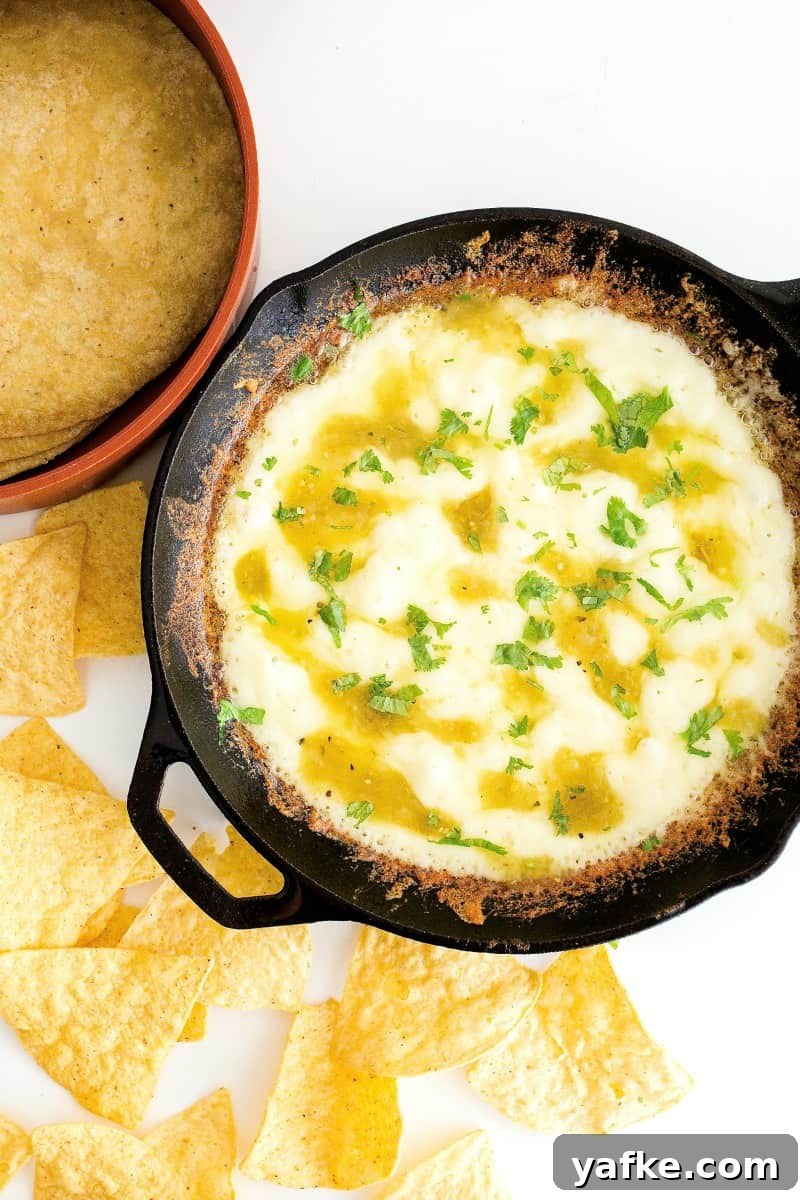 Skillet Queso Fundido: Gooey Melted Cheese Dip Recipe 2 Skillet queso fundido with melted cheeses and a crispy edge