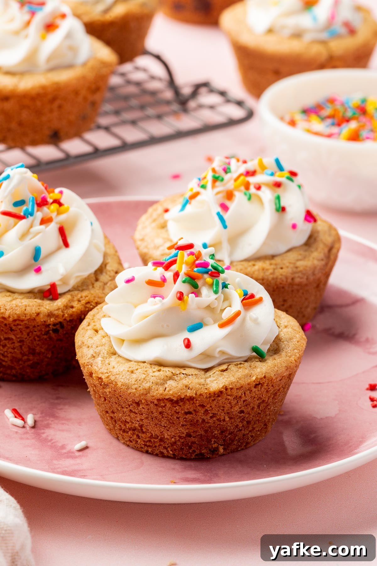 Gluten-Free Chocolate Chip Cookie Cups Recipe 12 Finished gluten-free cookie cups filled with vanilla frosting and sprinkles.