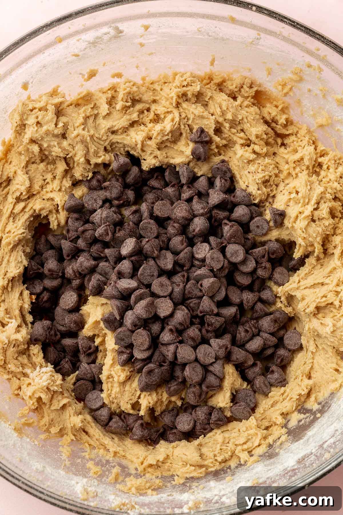 Gluten-Free Chocolate Chip Cookie Cups Recipe 7 A bowl of cookie dough with chocolate chips before folding.