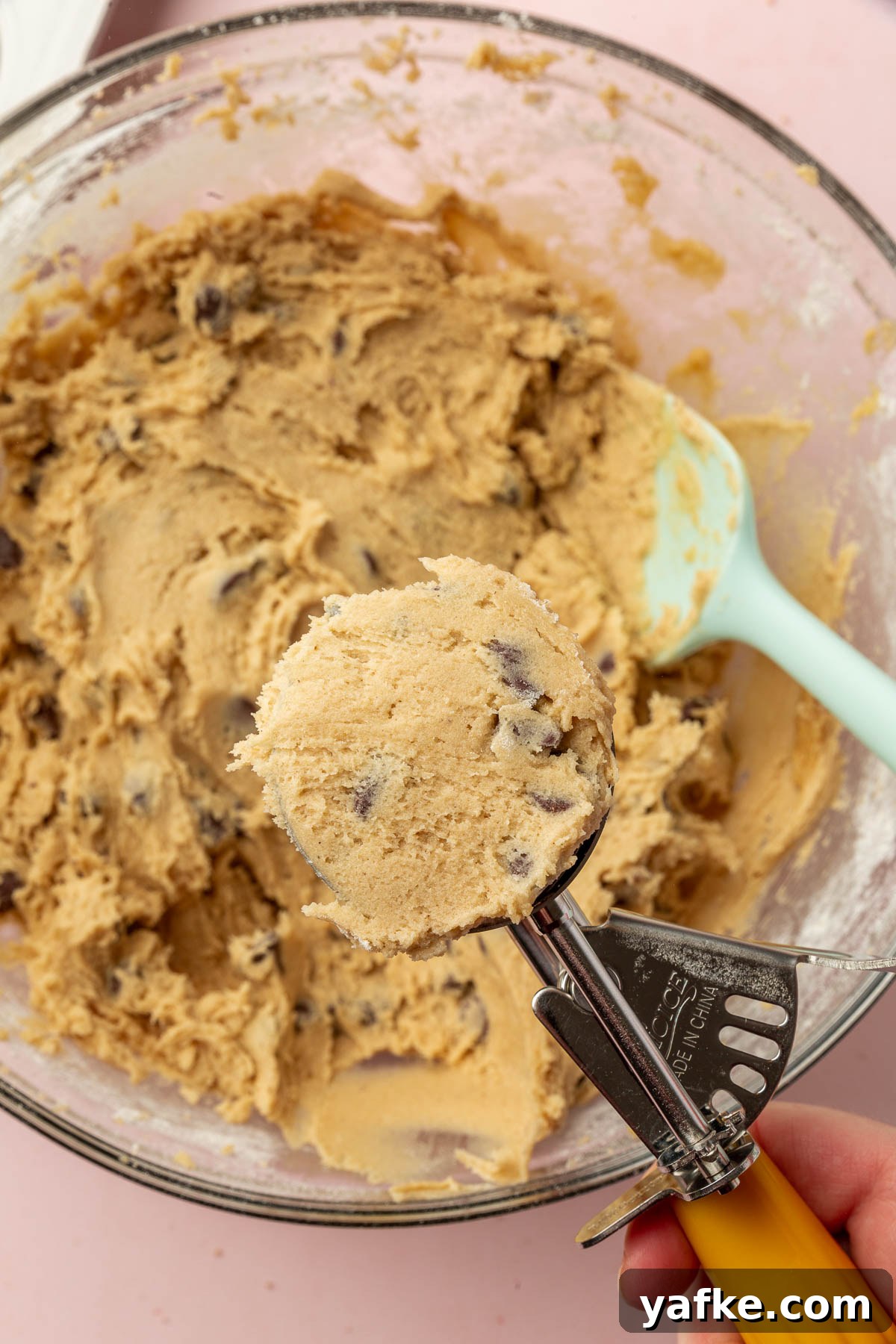Gluten-Free Chocolate Chip Cookie Cups Recipe 8 Scooping cookie dough into balls using a portion scoop.