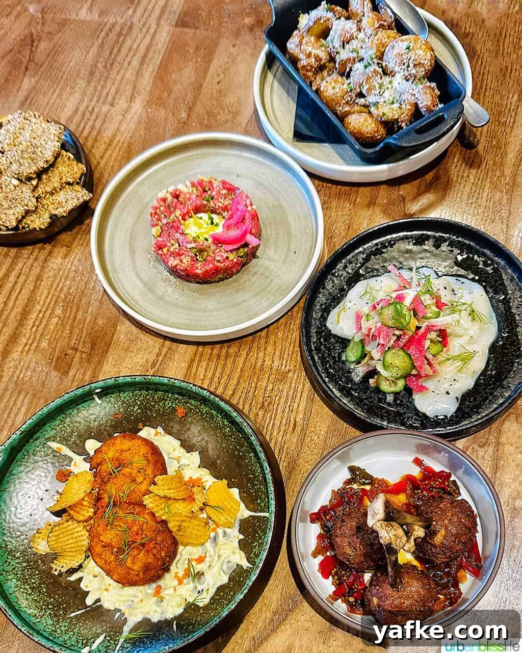 Bold Banff Adventures: What to Do in Banff National Park 2 several dinner dishes on a table at Brazen Banff restaurant.