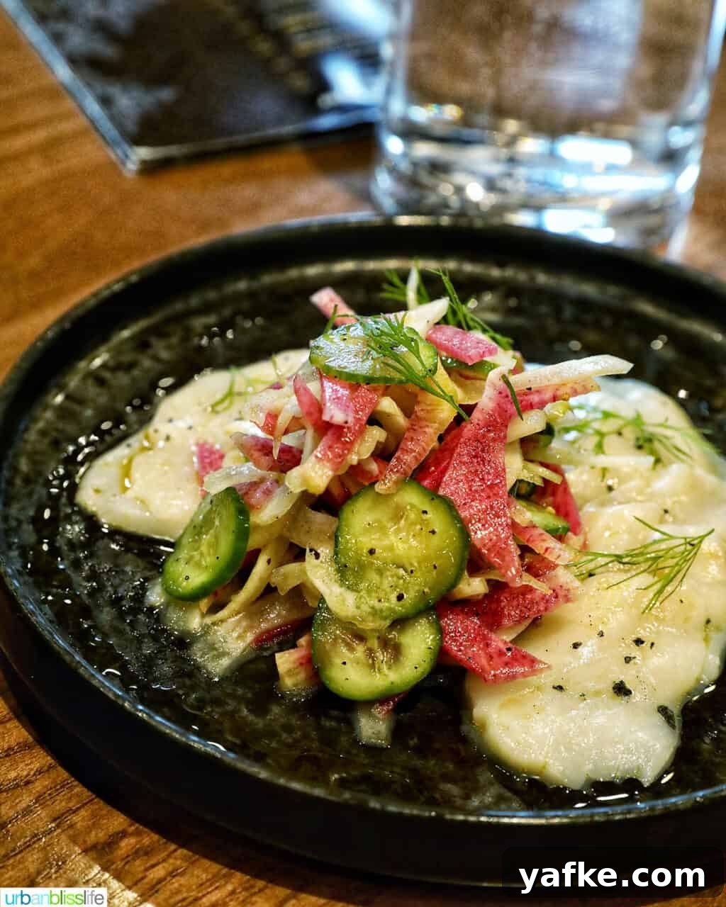 Bold Banff Adventures: What to Do in Banff National Park 8 Tuna crudo with veggies on a dark plate.