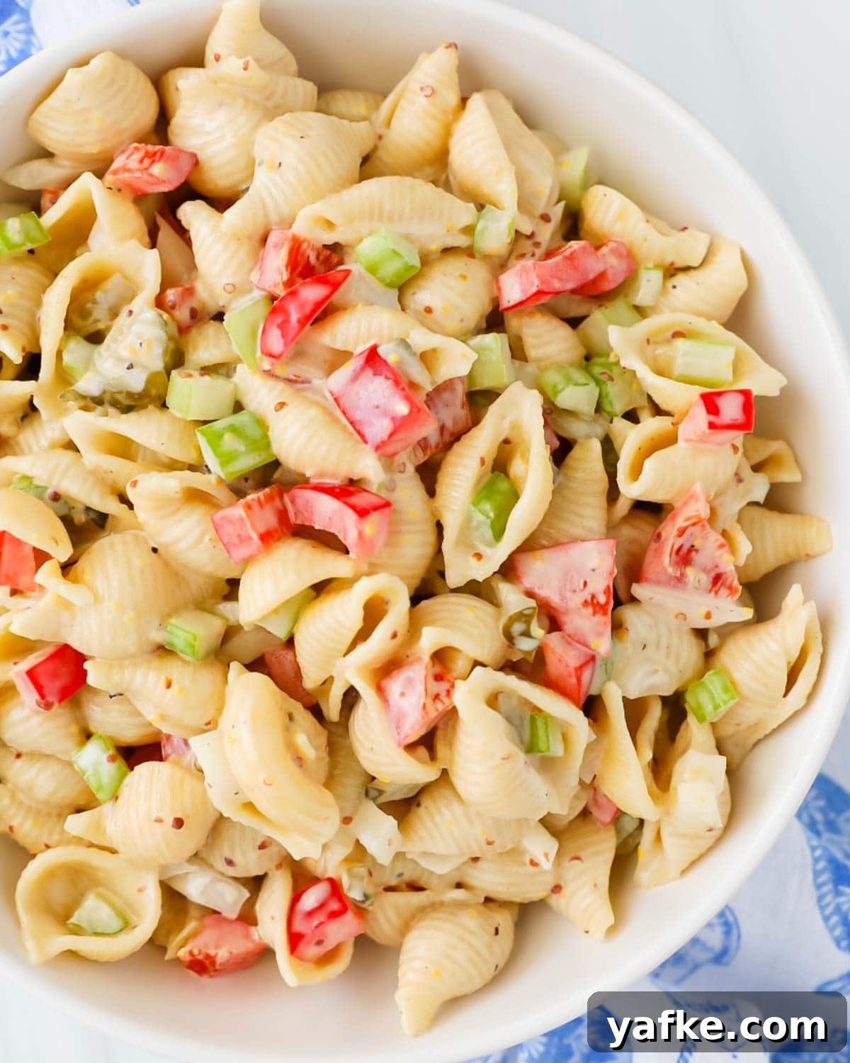 Creamy Vegan Macaroni Salad Recipe 2 Creamy vegan macaroni salad with shell pasta and vegetables