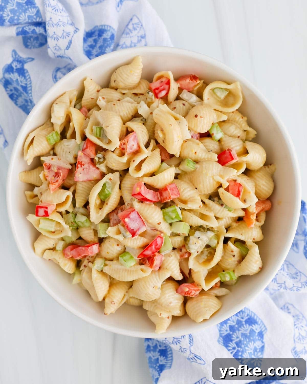 Creamy Vegan Macaroni Salad Recipe 4 Overhead of a white bowl with creamy pasta salad and fresh vegetables