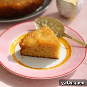 A slice of apple upside down cake on a plate.