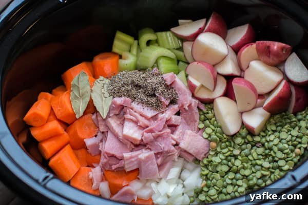 Hearty Slow Cooker Split Pea Stew Recipe 2 split peas, ham, red potatoes, carrots, onion, and seasoning in a slow cooker.