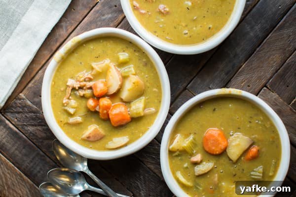 Hearty Slow Cooker Split Pea Stew Recipe 5 3 bowls of split pea stew on a wooden table.