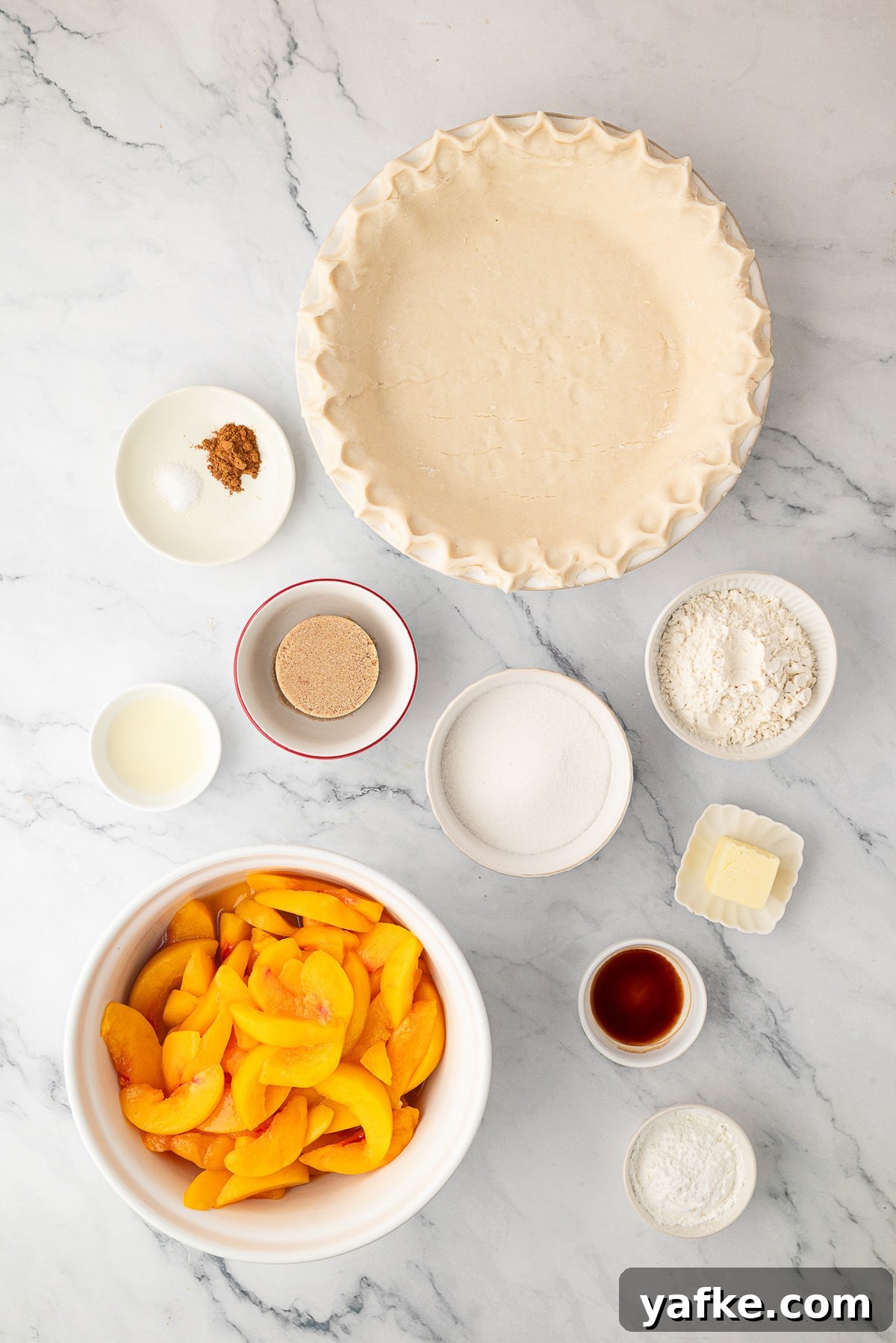 Classic Peach Crumble Pie with Brown Sugar Streusel 4 An overhead shot of the ingredients for a homemade peach crumble pie, including sliced peaches, light brown sugar, cinnamon, flour, butter and a deep dish pie crust.