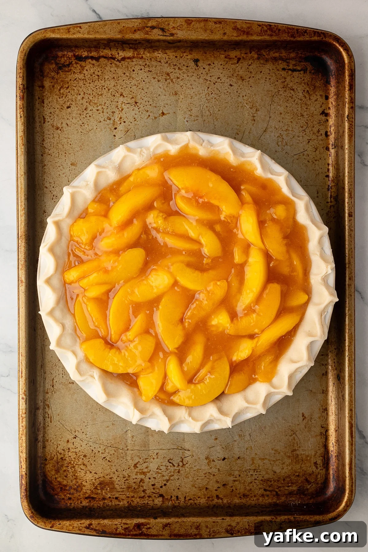 Classic Peach Crumble Pie with Brown Sugar Streusel 8 Thick peach pie filling piled high inside an unbaked deep-dish pie crust, leaving a one-third inch space at the top.