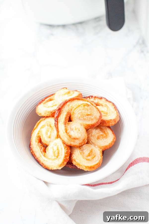 Air Fryer French Palmiers Recipe 6 Palmiers in a white bowl with an Air Fryer