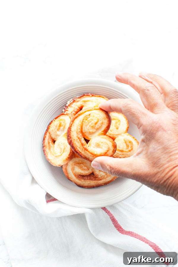 Air Fryer French Palmiers Recipe 7 Palmier cookies with a hand