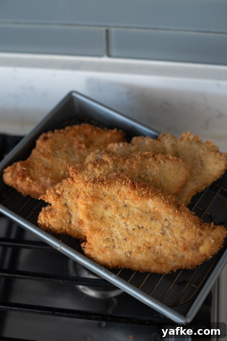 How to Make Crispy Japanese Tonkatsu in 30 Minutes 13 Freshly fried breaded cutlets resting on rack to stay crunchy
